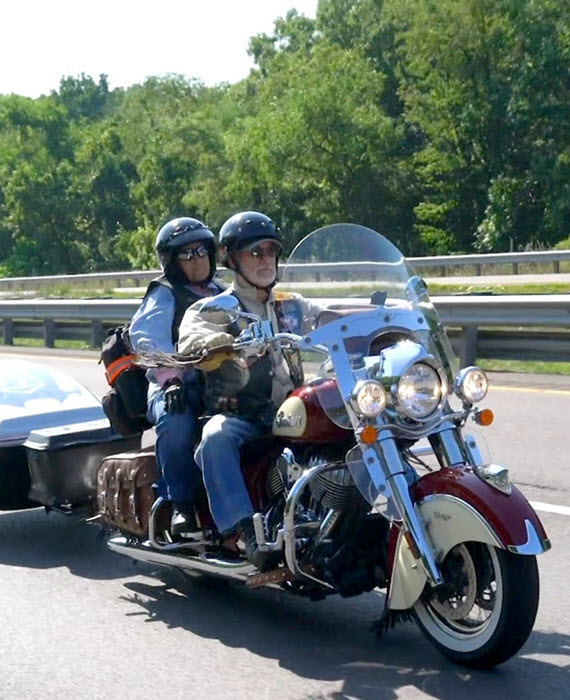 Two individuals enjoy a motorcycle ride